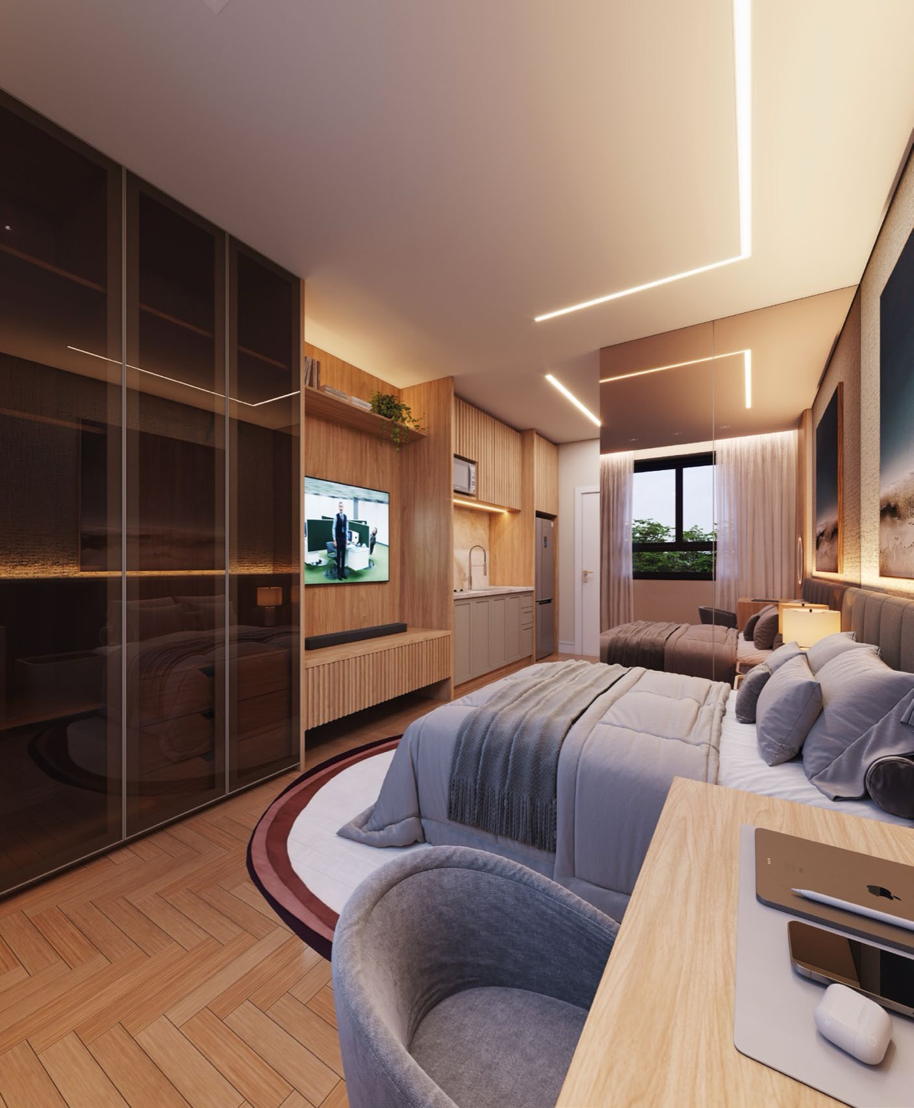 Interior de studio padrão do Lumière, com cama de casal, cozinha integrada e bancada de trabalho